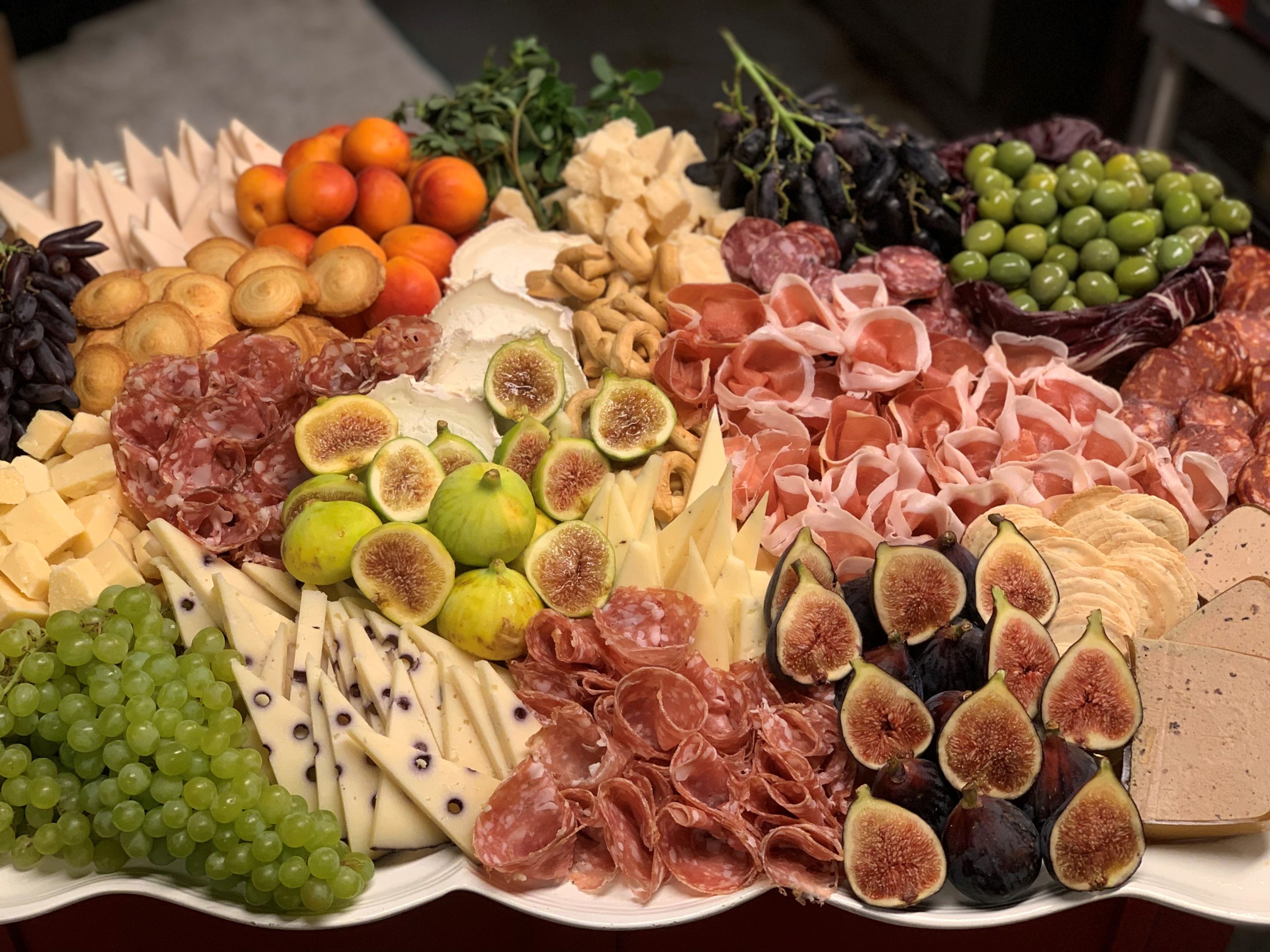 Cafasso's charcuterie and cheese catering board with seasonal fruit and accompaniments